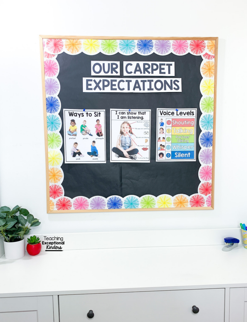 A bulletin board with visual supports  labeled "Our Carpet Expectations"