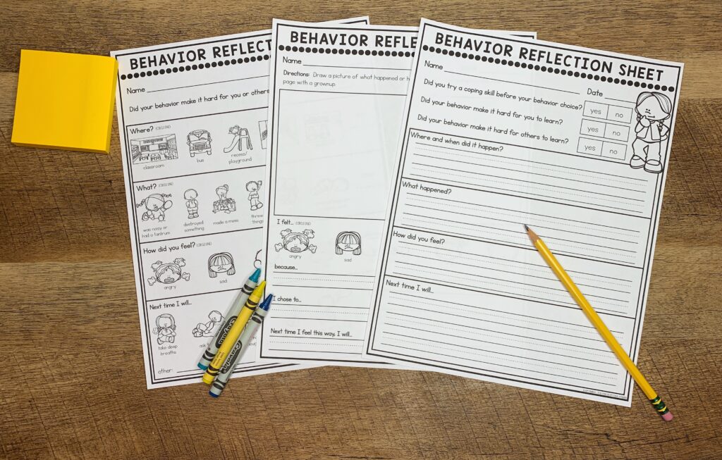 Three types of behavior reflection sheets sit in a desk