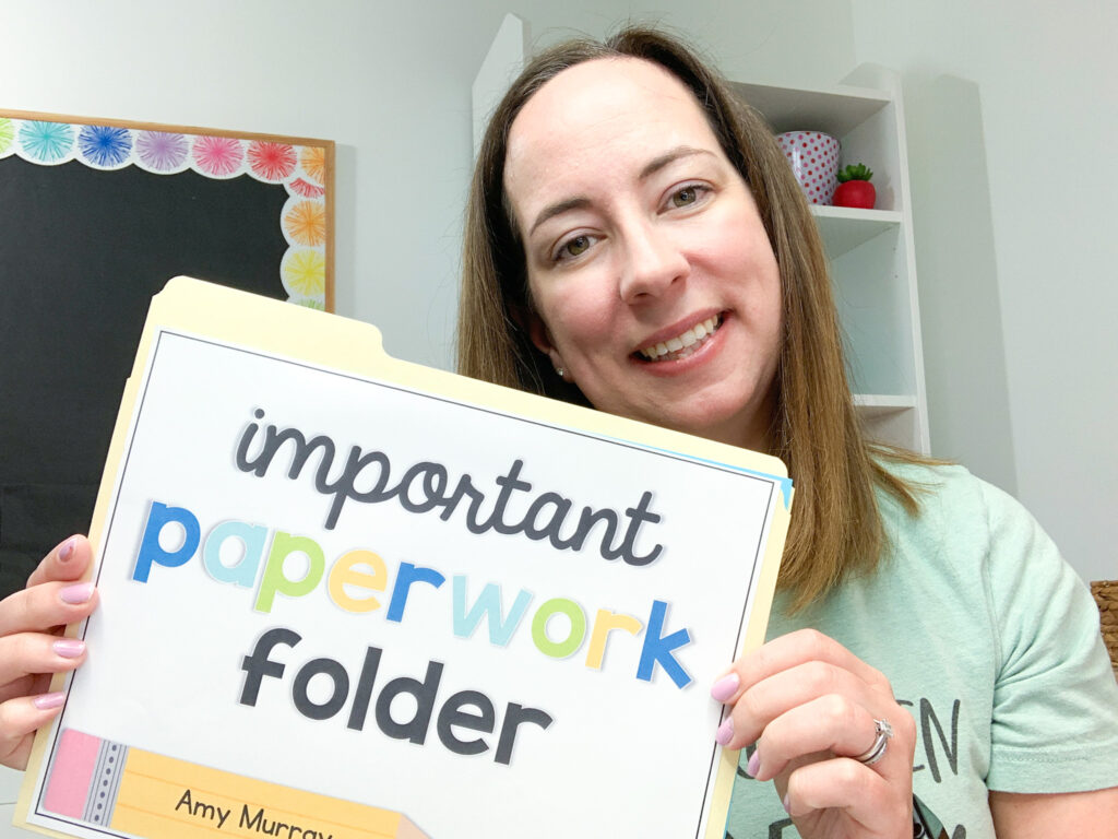 Smiling Amy holding a folder with an Important Paperwork Folder label
