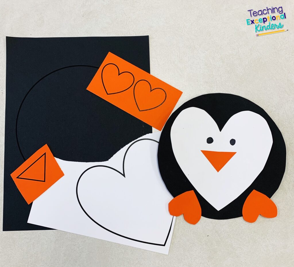 A completed penguin craft and the paper pieces used to make it